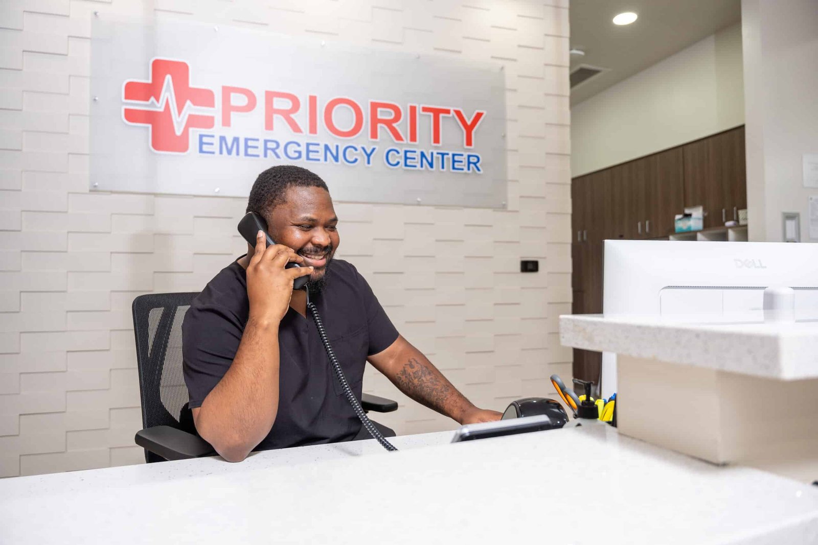 Front Desk Staff Answering Phone Priority Emergency Center Austin TX