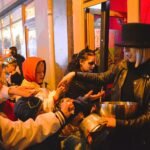 Children trick-or-treating on a town street, a key part of Halloween safety by age