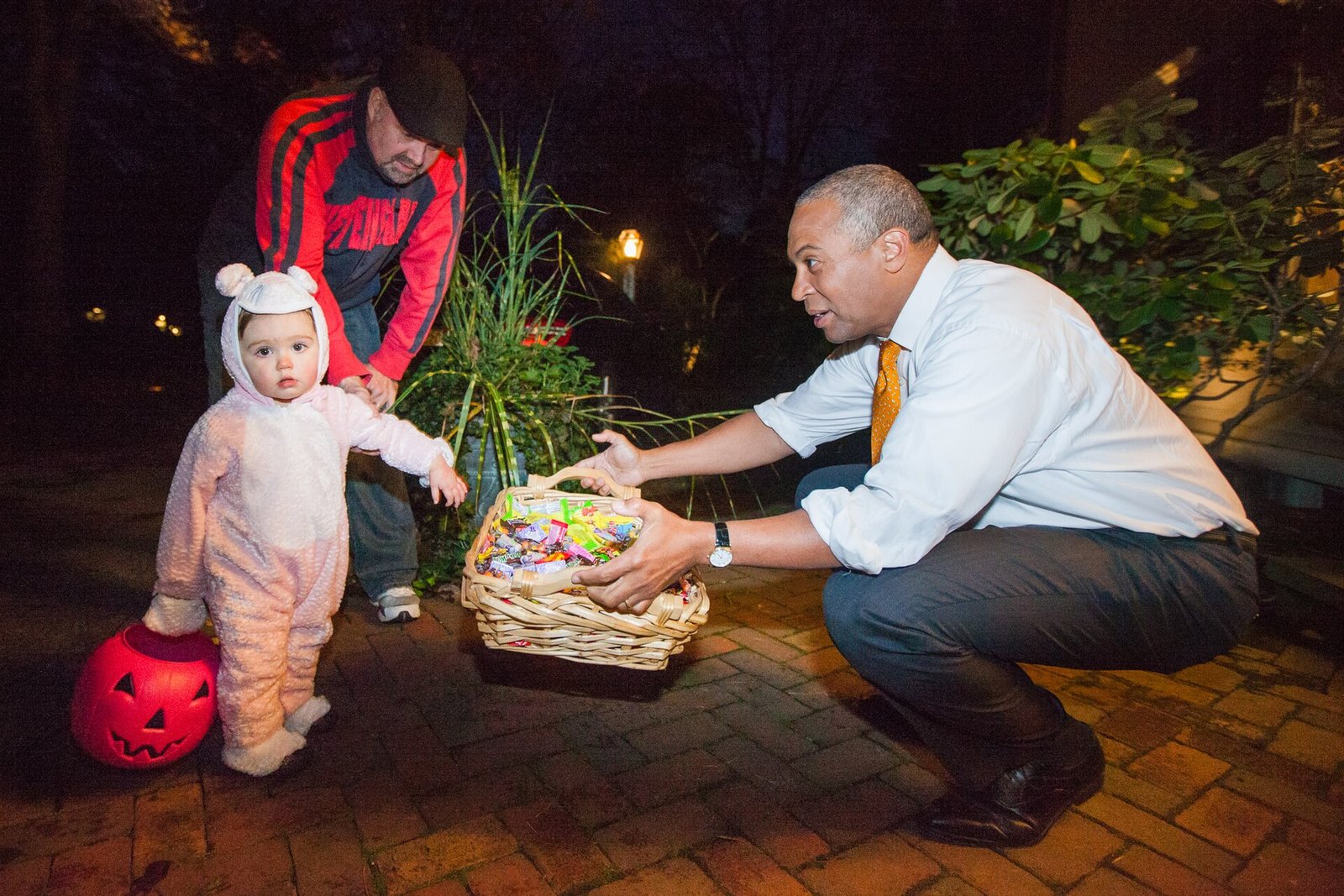 Trick-or-treaters greeted at a front door, Halloween safety by age for adults and kids