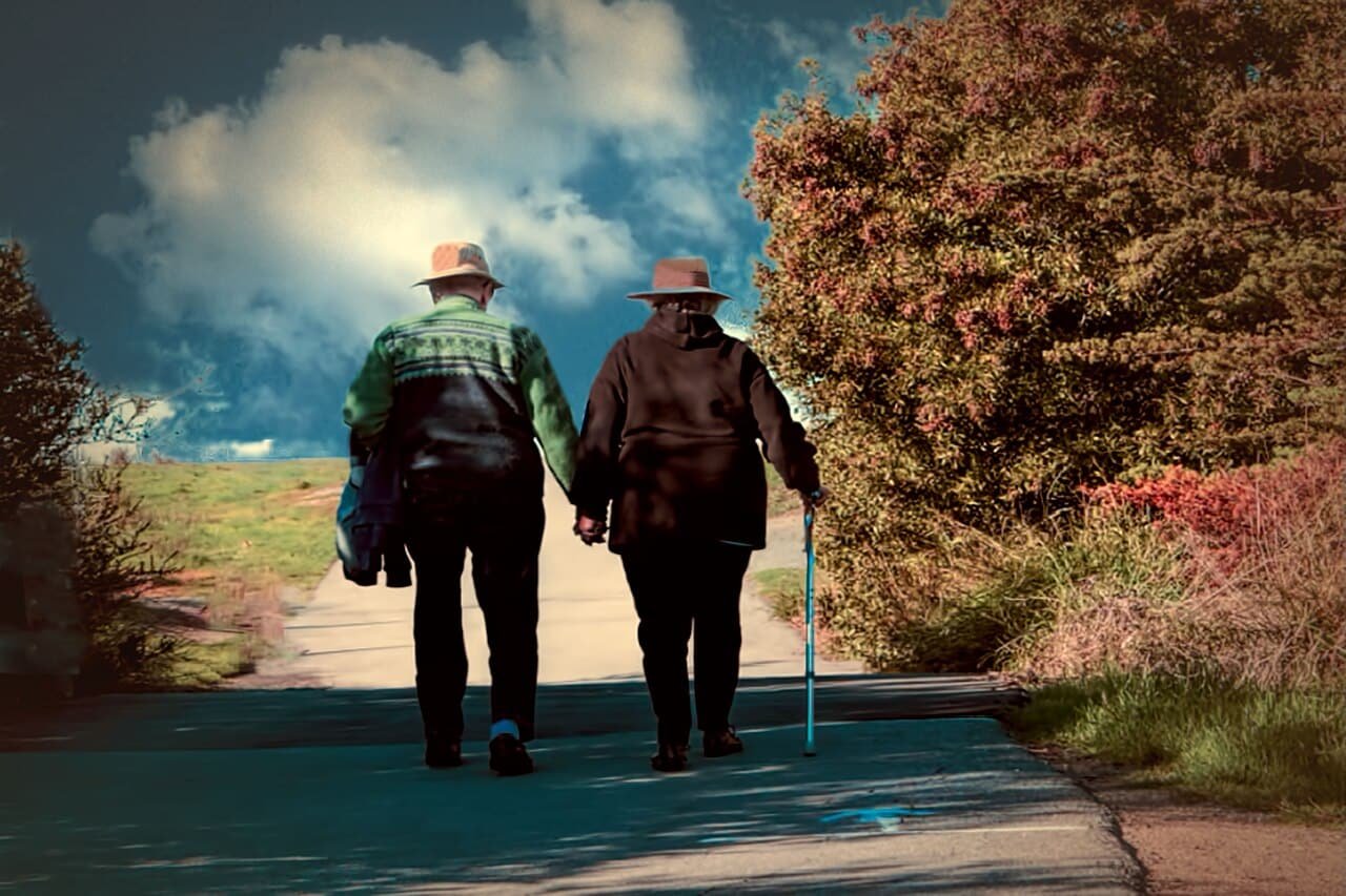 Senior couple walking in a park, a reminder of protecting seniors and infants during extreme Austin heat or cold